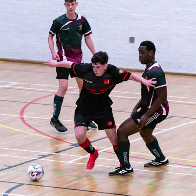 Staffs player takes control of the ball through a battle with the opposition 