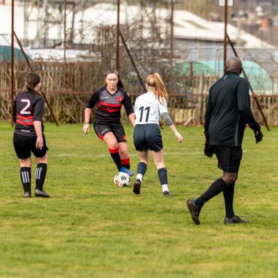 The opposition player number 11 runs towards Staffs player with control of the ball