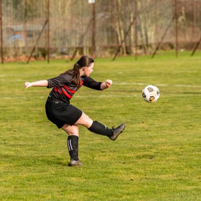 Staffs player takes a cross to her teammate 