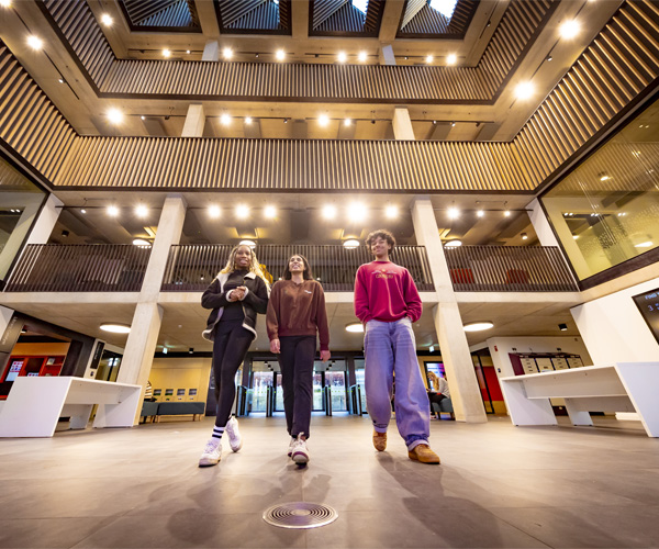 Students are walking and chatting at the entrance of the catalyst