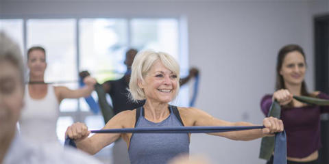 An older woman exercising with resistance bands