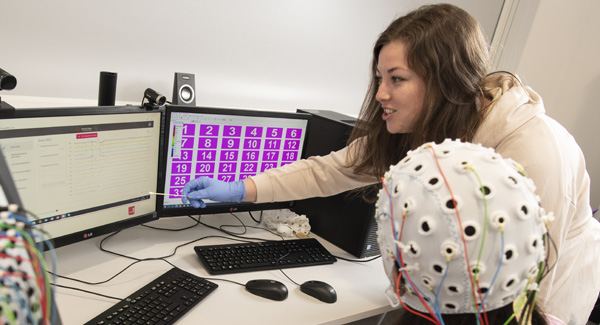 Two female students are working in the psychology lab together on an experiment