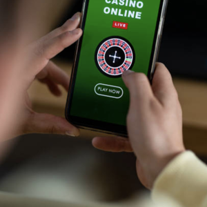 Hands holding a mobile phone with an online casino game on the screen 